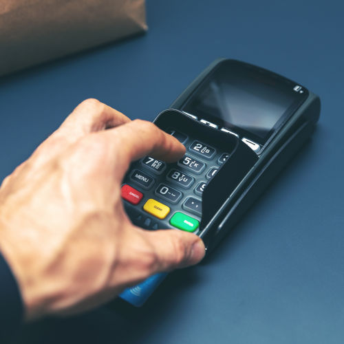 Credit Card Purchase At Store Hand Entering Pin Code