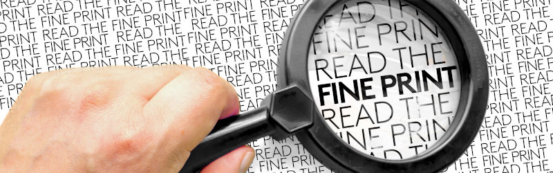 A Person With A Magnifying Glass Looking To Text: Read The Fine
