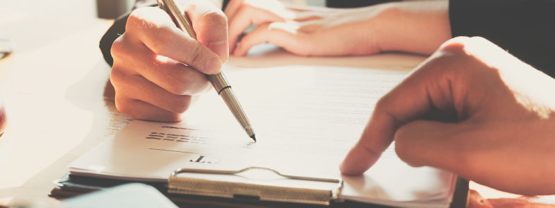 Business Woman Signing A Contract. Close Up Of Two Business Part